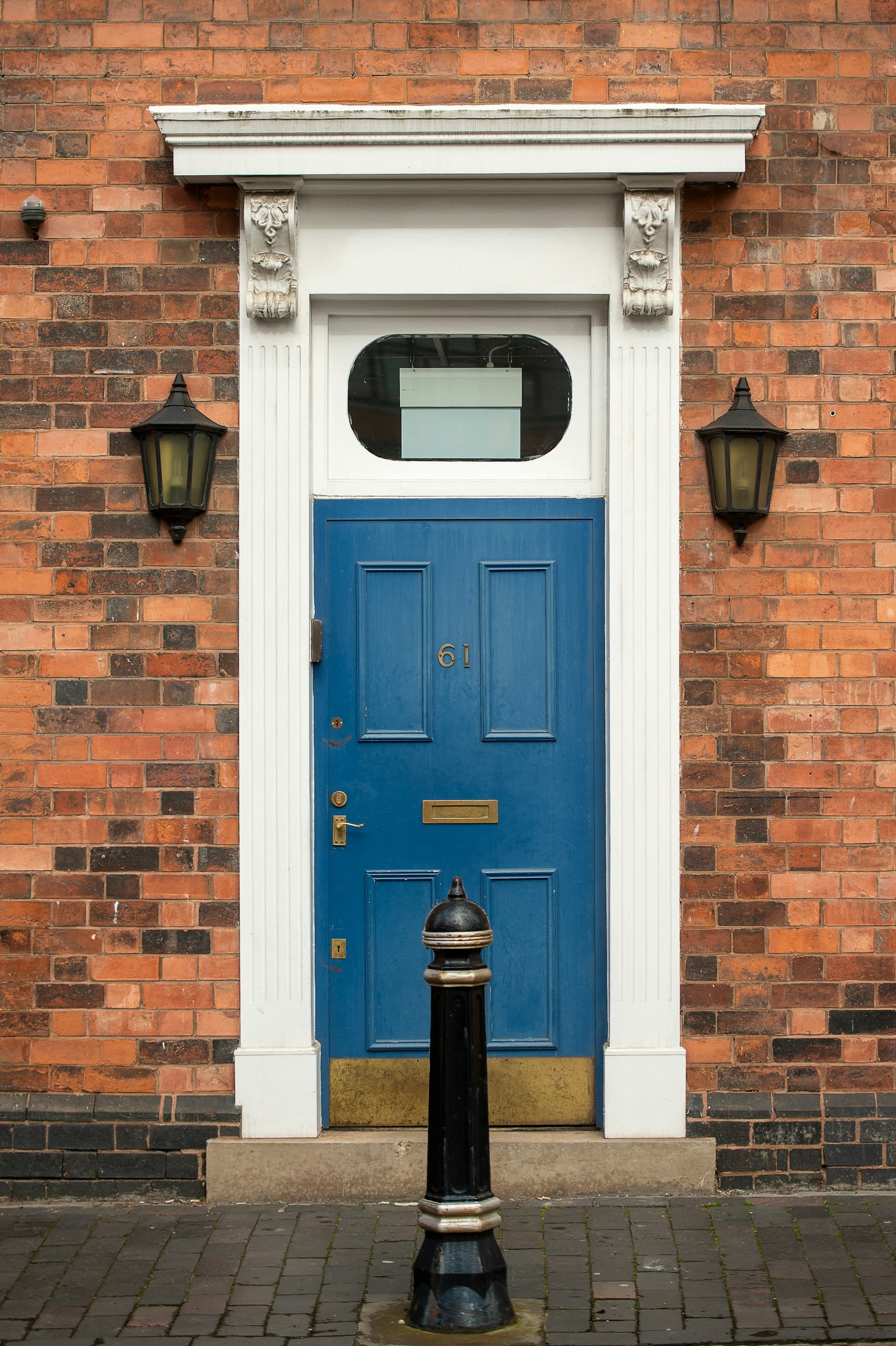 A painted blue front door on a brick townhouse in Birmingham, UK